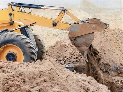 how to backfill with a skid steer|backfilling a foundation trench.